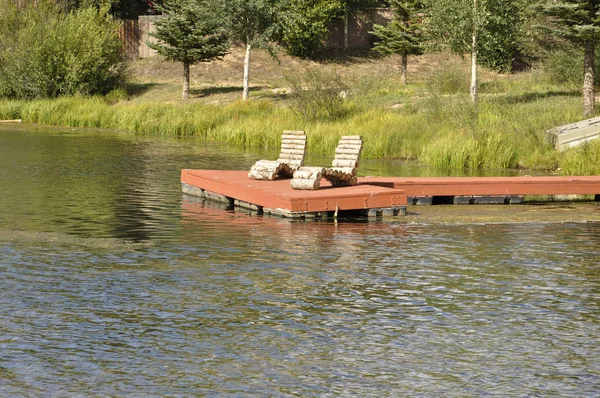 Dock by a pond Royalty Free Stock Photos