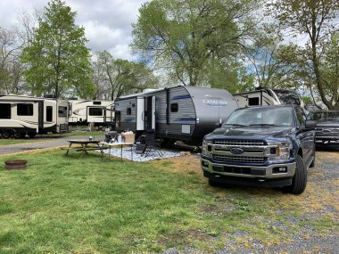 Gettysburg, Pennsylvania/USA - May 1, 2020:  Recreational vehicles fill a private campground in Pennsylvania as state lockdowns ease up. clipart