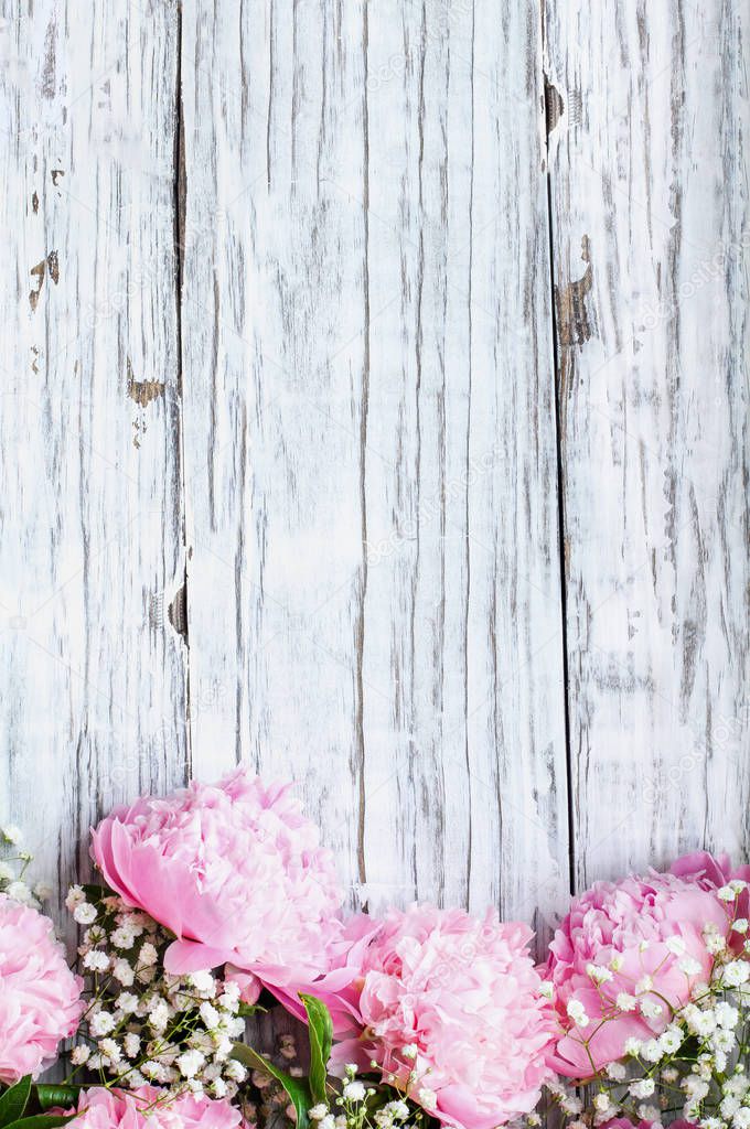 Bouquet of Pink Peonies and Babys Breath Flowers over a White Ru