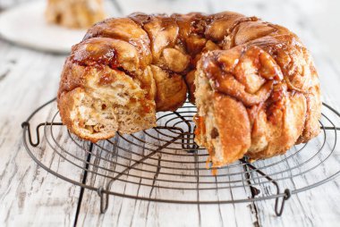 Easter dessert of Pull Apart Carrot Cake Monkey Bread. A yeast bundt cake made with cinnamon, carrots, nuts and a brown sugar glaze. Selective focus with blurred foreground and background. clipart