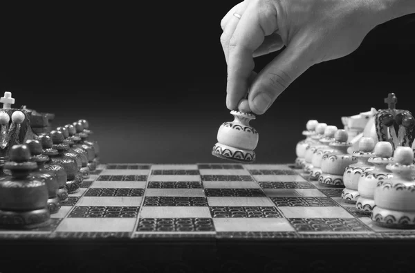 Male hand moving white pawn at the beginning of chess game. — Stock Photo, Image