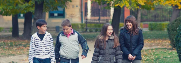 Happy adolescente meninos e menina se divertindo e andando no outono — Fotografia de Stock