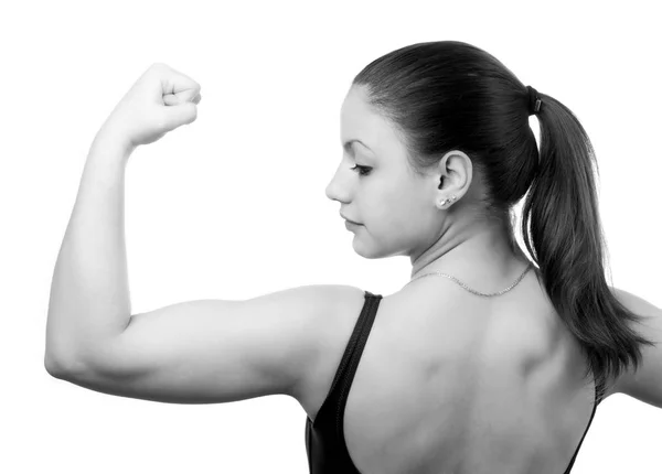 Muscular young fitness girl flexing her biceps muscles — Stock Photo, Image