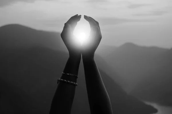 Female hands holding sun on sunny summer day — Stock Photo, Image