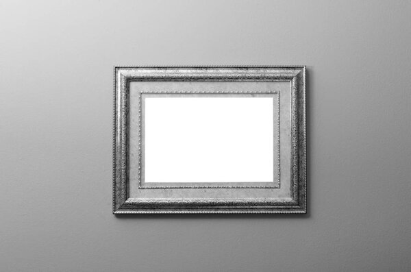 Beautiful old wooden painting frame mounted on the wall in black and white