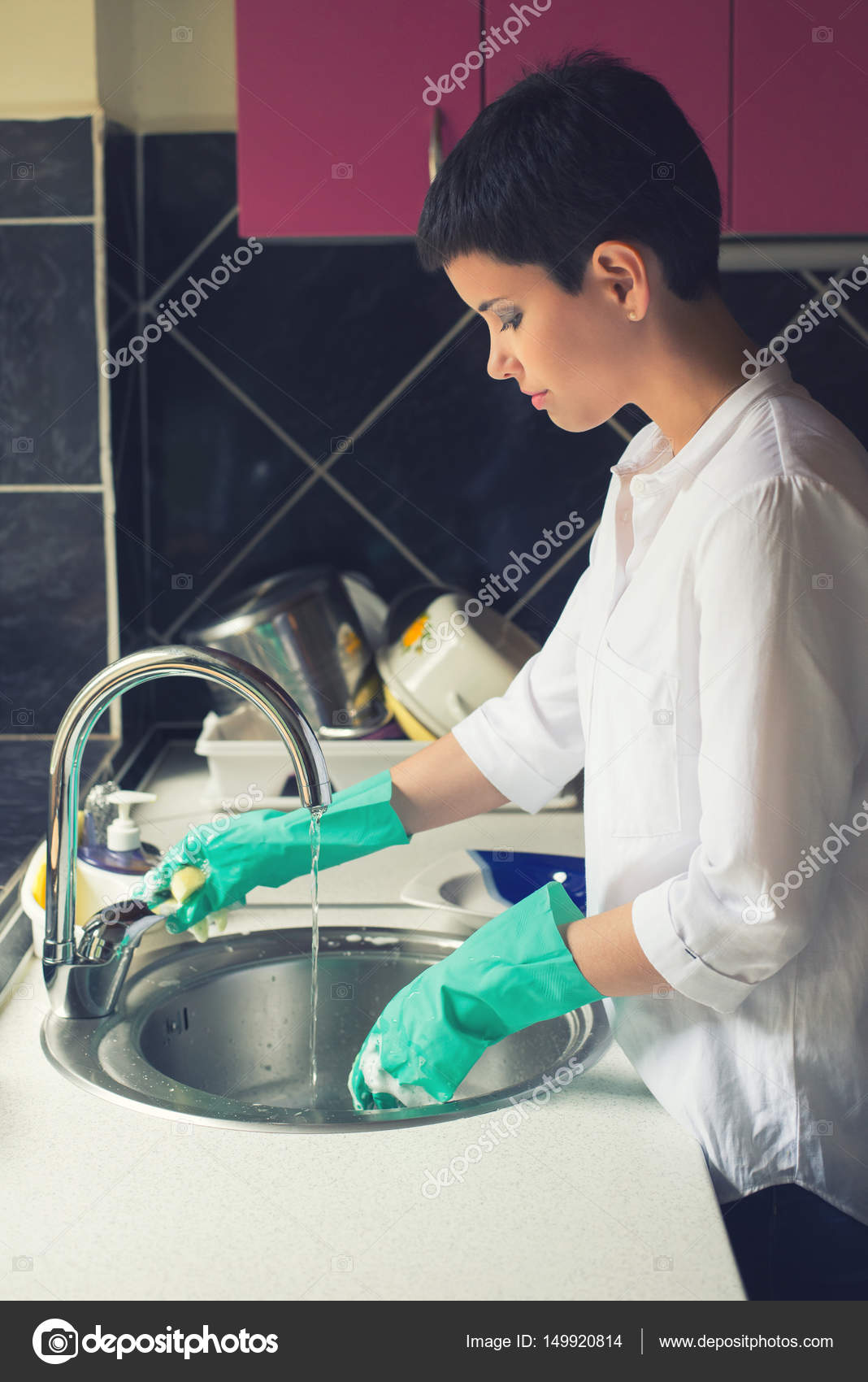 Beautiful Girl With Short Hair Washing Dishes In Modern Kitchen