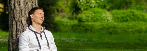 Happy young man relaxing in the park Stock Photo