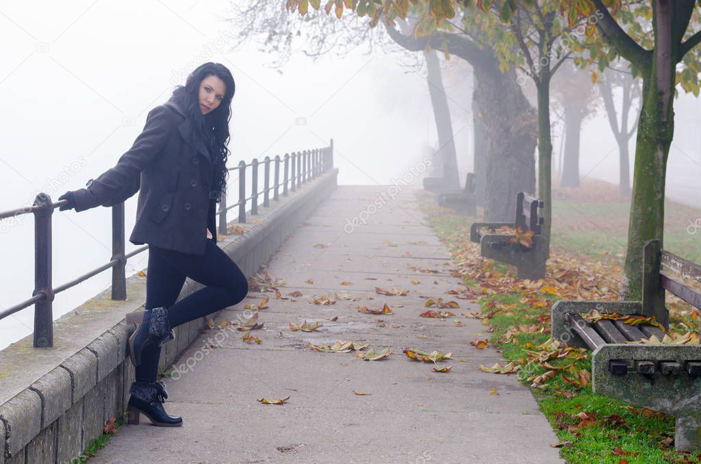 Young woman outdoor on misty autumn day