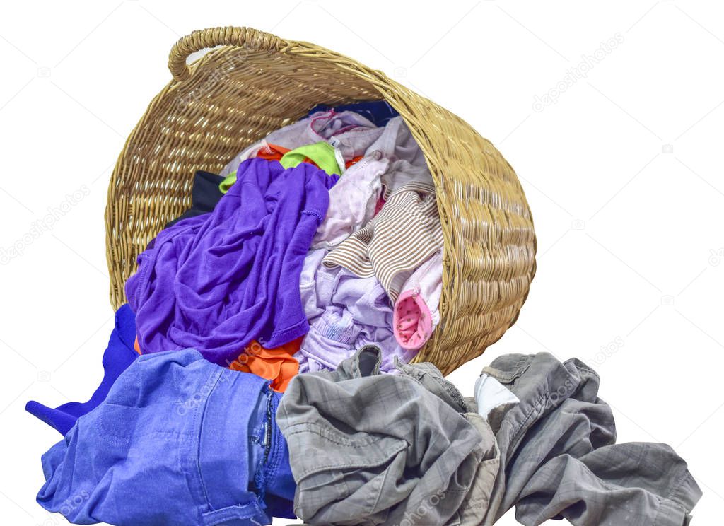 Many clothes with in wicker basket on isolated white background