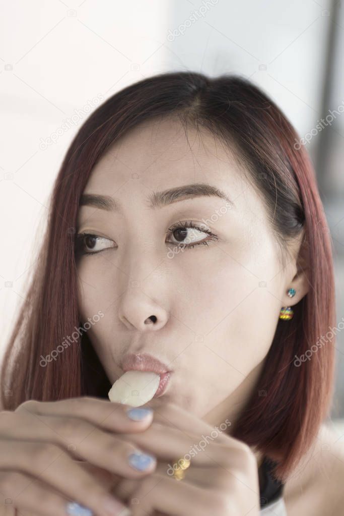 Closeup woman lick lollipop