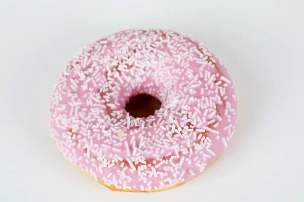 Pink donut with sprinkles — Stock Photo, Image