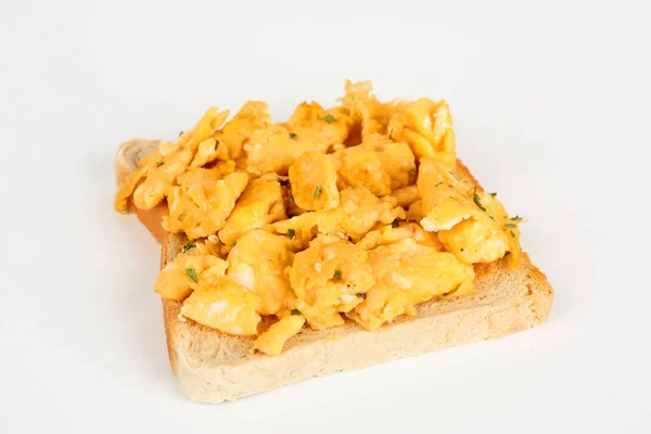 Scrambled eggs on a bread — Stock Photo, Image