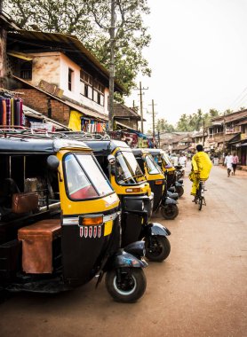 yellow rickshaws, tuk tuk in streets of Gokarna, Karnataka, India clipart