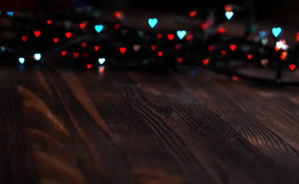 Heart bokeh, Valentines day concept on wooden background — Stock Photo, Image