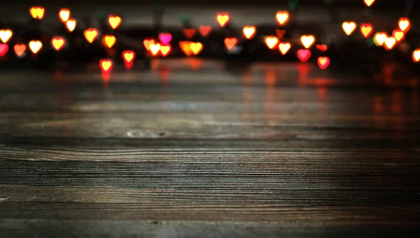 Bokeh srdce, Valentýn koncept na dřevěné pozadí — Stock fotografie