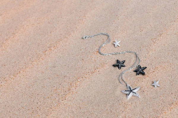 Pendant on sea sand — Stock Photo, Image