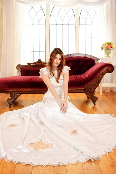 Portrait of bride sitting on floor by window — Stock Photo, Image