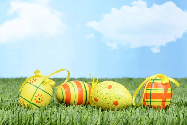 Easter eggs with bows in grass — Stock Photo, Image