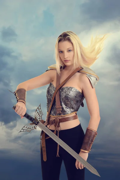 Female warrior with sword and hair blowing in wind — Stock Photo, Image