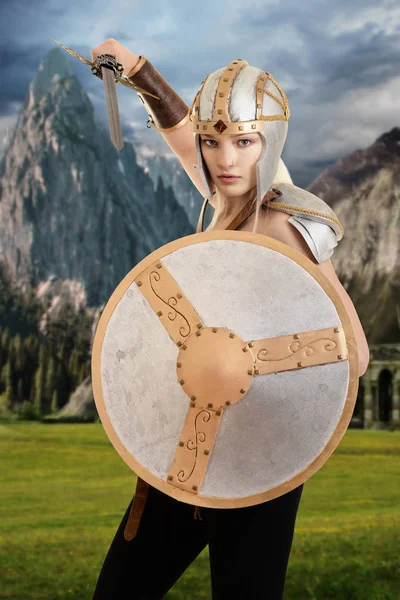 Female warrior attacking with shield and sword — Stock Photo, Image