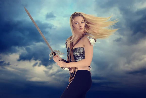 Woman warrior with cloudy sky background — Stock Photo, Image