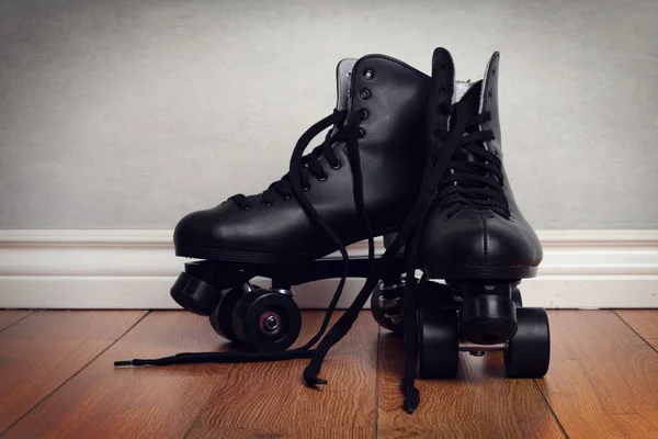 Patins masculinos no chão de madeira — Fotografia de Stock