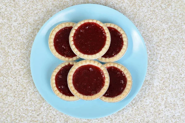 Top view strawberry tarts on blue plate — Stock Photo, Image