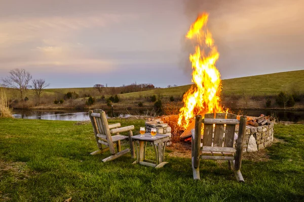 Bonfire in a fire pit at sunset — Stock Photo, Image