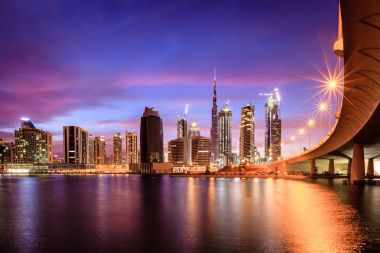 View of Dubai downtown skyline at night clipart