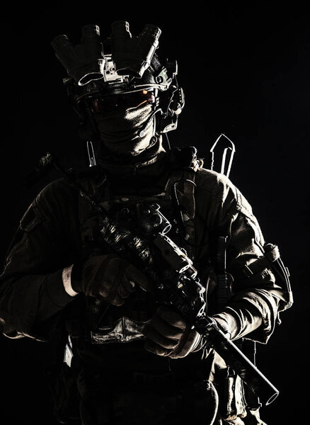 Army elite troops serviceman standing in darkness
