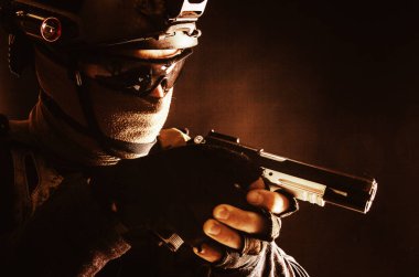 Police SWAT team fighter aiming service pistol