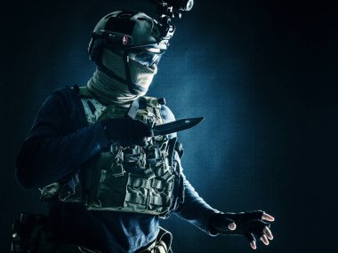Commando fighter creeping in darkness with knife