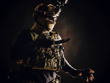 Commando fighter creeping in darkness with knife