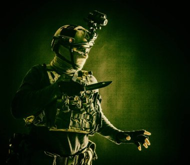Commando fighter creeping in darkness with knife