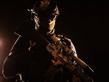 Army marksman with sniper rifle in darkness