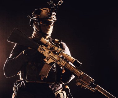 Army marksman with sniper rifle in darkness