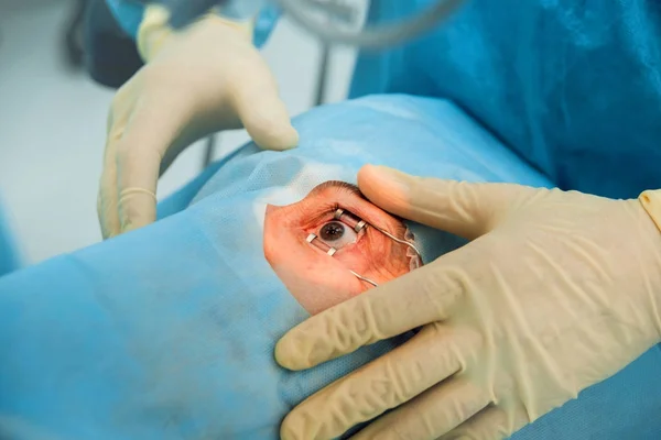 Operation on the eye of senior woman. Cataract surgery. Medical equipment.
