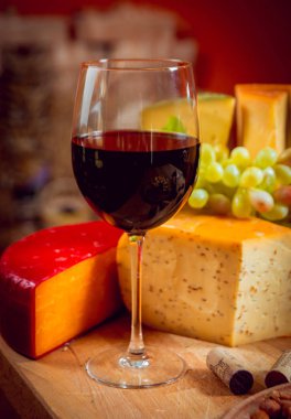 Tahta bir masada peynir ve şarap.