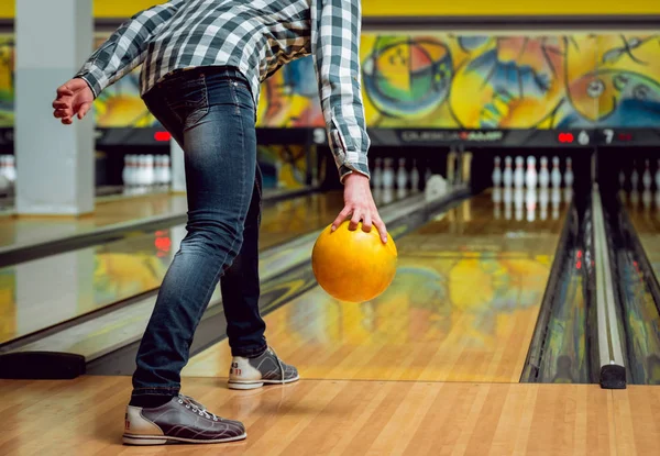 Young man at the bowling alley with ball