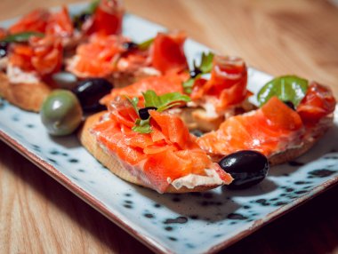 Sandviç somon ve bir plaka üzerinde zeytin ile