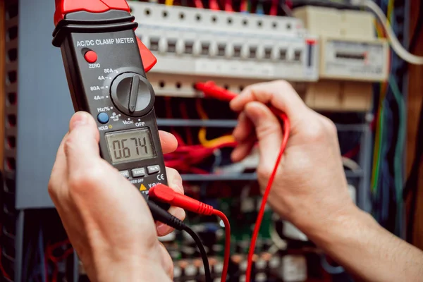 Electrical equipment. Tester in the hands.