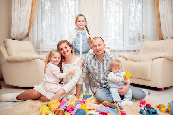 Cheerful young family having fun at home