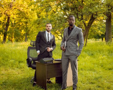 İki genç çok kültürlü iş adamları iş park yerinde. Uzak iş kavramı.