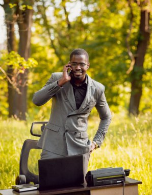 Park içinde İşte genç Afro-Amerikalı iş adamı. Uzak iş kavramı.