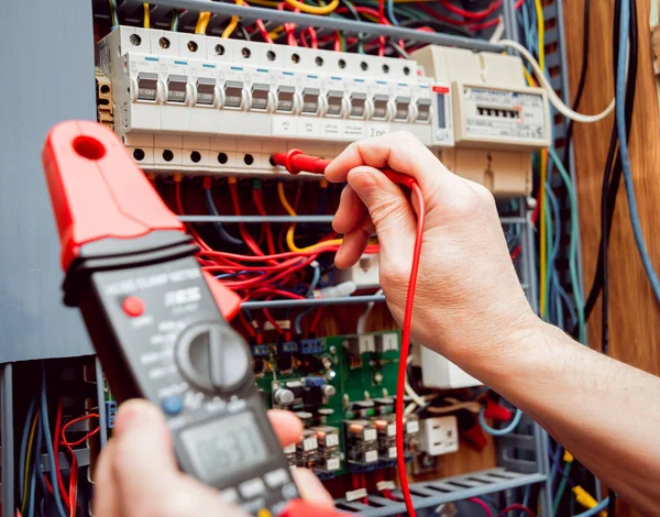 Electrical equipment. Tester in the hands.