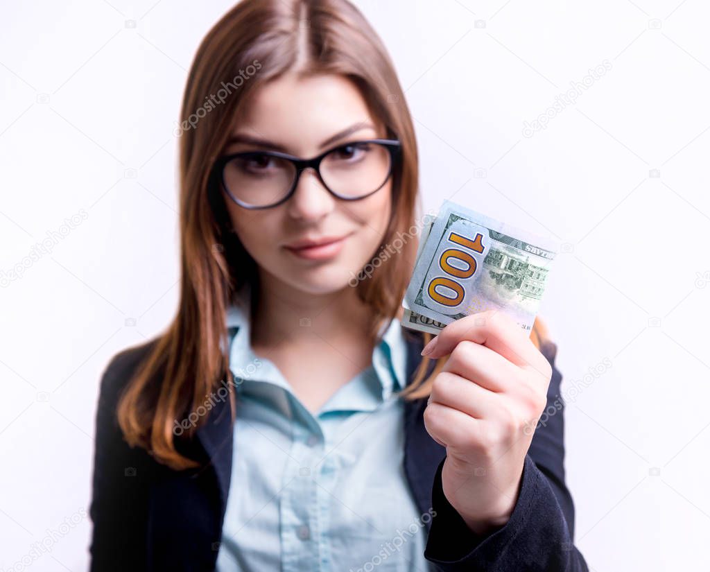 Businesswoman in glasses with one hundred dollar bill