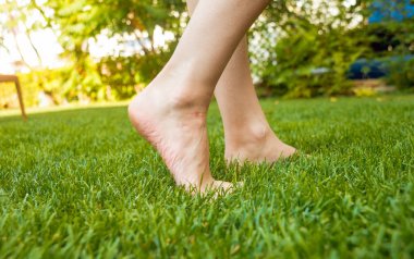 Kadın ayakları üzerinde yeşil çim.