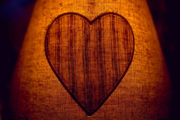 Night lamp with a heart in the bedroom. Background