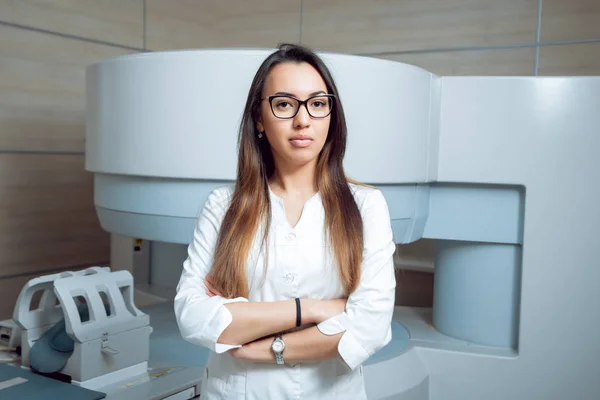 Young female middle eastern doctor at MRI room. Medical equipment.