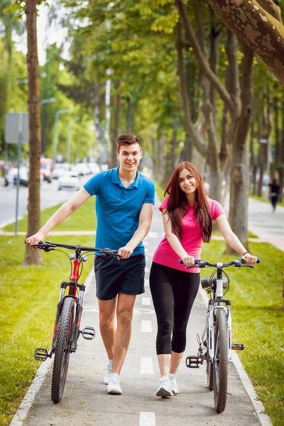 Jovem Casal Caucasiano Ciclismo Pista Bicicleta Verde Dia Ensolarado — Fotografia de Stock